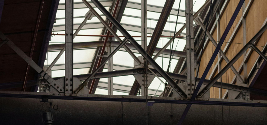 Workers wearing PPE in a structural steel fabrication environment